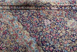Close-up detail of 1970s Kerman rug from Iran / Persia showing Wool weave
