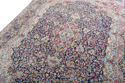 Backside of handmade 1970s Kerman rug showing knot structure and weave density