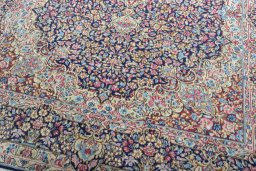 Close-up detail of 1970s Kerman rug from Iran / Persia showing Wool weave