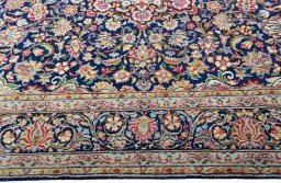 Corner detail of 2000s Kerman rug showing border pattern and Wool pile