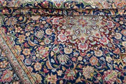 Close-up detail of 2000s Kerman rug from Iran / Persia showing Wool weave