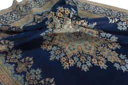 Surface texture of 2000s Kerman rug with natural Wool and intricate pattern