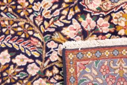 Close-up detail of 1980s Kerman rug from Iran / Persia showing Wool weave
