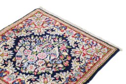 Surface texture of 1990s Kerman rug with natural Wool and intricate pattern