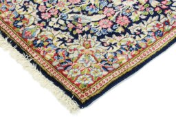 Backside of handmade 1990s Kerman rug showing knot structure and weave density