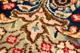 Backside of handmade 1990s Kerman rug showing knot structure and weave density