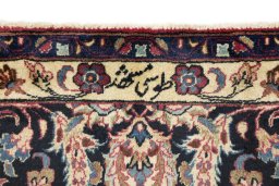 Backside of handmade 1960s Mashad rug showing knot structure and weave density