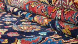 Full view of 1960s Mashad rug from Iran / Persia, 498 × 335 cm in Dark blue tones