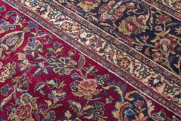 Backside of handmade 1970s Mashad rug showing knot structure and weave density