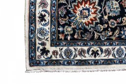 Backside of handmade New Mashad rug showing knot structure and weave density