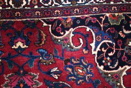 Surface texture of 1950s Mashad rug with natural Wool and intricate pattern
