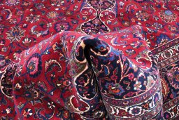 Backside of handmade 1950s Mashad rug showing knot structure and weave density
