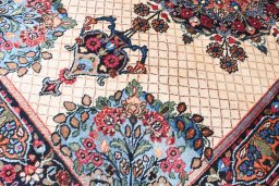 Corner detail of 1950s Mashad rug showing border pattern and Wool pile