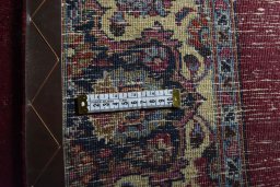 Surface texture of 1950s Mashad rug with natural Wool and intricate pattern