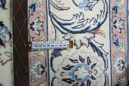 Backside of handmade New Mashad rug showing knot structure and weave density