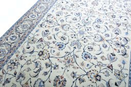 Backside of handmade New Mashad rug showing knot structure and weave density