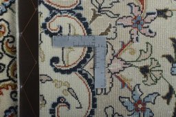 Backside of handmade New Mashad rug showing knot structure and weave density