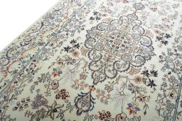 Backside of handmade New Mashad rug showing knot structure and weave density