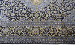 Corner detail of 2000s Mashad rug showing border pattern and Wool pile