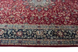 Corner detail of 2000s Mashad rug showing border pattern and Wool pile