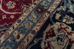 Close-up detail of 2000s Mashad rug from Iran / Persia showing Wool weave
