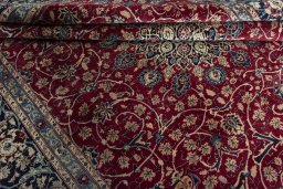 Surface texture of 2000s Mashad rug with natural Wool and intricate pattern
