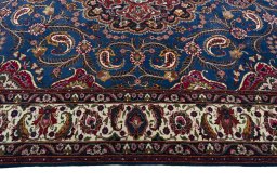 Corner detail of 2000s Mashad rug showing border pattern and Wool pile