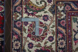 Backside of handmade 2000s Mashad rug showing knot structure and weave density