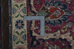 Backside of handmade 1970s Mashad rug showing knot structure and weave density