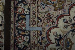 Backside of handmade 2000s Mashad rug showing knot structure and weave density