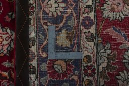 Backside of handmade 2000s Mashad rug showing knot structure and weave density