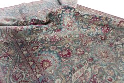 Surface texture of 1950s Mashad rug with natural Wool and intricate pattern