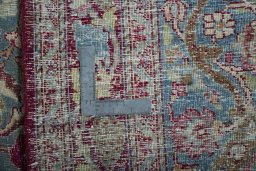 Backside of handmade 1950s Mashad rug showing knot structure and weave density