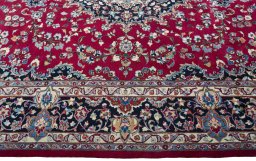 Corner detail of 2000s Mashad rug showing border pattern and Wool pile