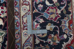 Backside of handmade 2000s Mashad rug showing knot structure and weave density