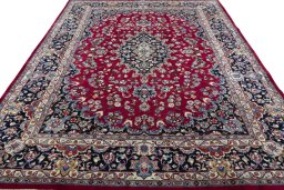 Surface texture of 2000s Mashad rug with natural Wool and intricate pattern