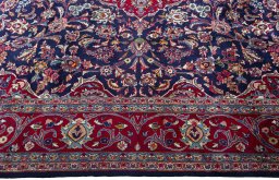 Corner detail of 2000s Mashad rug showing border pattern and Wool pile