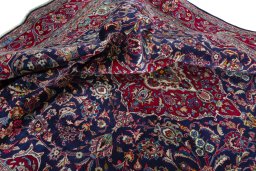Surface texture of 2000s Mashad rug with natural Wool and intricate pattern
