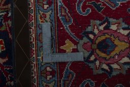 Backside of handmade 2000s Mashad rug showing knot structure and weave density