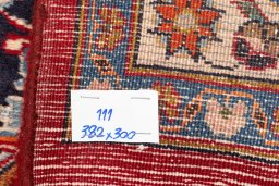 Corner detail of 2000s Mashad rug showing border pattern and Wool pile
