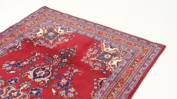 Surface texture of 2000s Mashad rug with natural Wool and intricate pattern