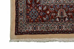 Backside of handmade New Moud rug showing knot structure and weave density