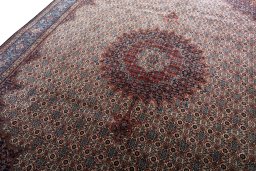 Backside of handmade New Moud rug showing knot structure and weave density