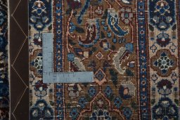 Backside of handmade 2000s Moud rug showing knot structure and weave density