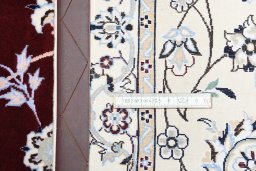 Backside of handmade New Nain rug showing knot structure and weave density