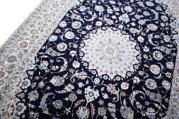 Backside of handmade New Nain rug showing knot structure and weave density