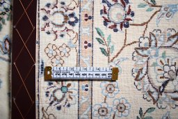 Backside of handmade New Nain rug showing knot structure and weave density