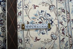 Backside of handmade New Nain rug showing knot structure and weave density