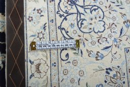 Backside of handmade New Nain rug showing knot structure and weave density