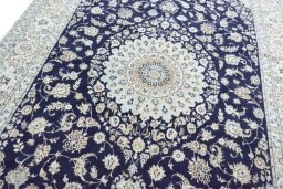 Backside of handmade New Nain rug showing knot structure and weave density